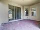 Covered patio with brick pavers and a sliding glass door creates a private retreat at 9971 Beach Port Dr, Winter Garden, FL 34787