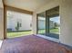 Covered brick patio with a sliding glass door offers seamless indoor/outdoor living at 9971 Beach Port Dr, Winter Garden, FL 34787