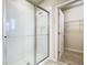 Modern bathroom featuring a sleek glass shower enclosure with a tiled interior and a grab bar at 9971 Beach Port Dr, Winter Garden, FL 34787