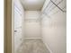 Well-sized walk-in closet features wire shelving and a door for privacy and functionality at 9971 Beach Port Dr, Winter Garden, FL 34787