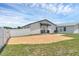 Spacious backyard with a brick patio and a well-maintained lawn and fence at 1050 20 St, Orlando, FL 32805