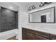 Modern bathroom with double sinks, dark cabinets, and a shower over tub, showcasing stylish fixtures at 1050 20 St, Orlando, FL 32805