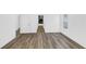 Bedroom with wood-look floors leads to a bathroom with a walk-in shower and soaking tub at 1050 20 St, Orlando, FL 32805