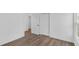 Bright bedroom showcasing an ensuite bathroom with two closet doors and vinyl floor at 1050 20 St, Orlando, FL 32805