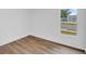 Bright bedroom features wood-look floors and a large window bringing in natural light at 1050 20 St, Orlando, FL 32805