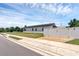 Street view of a modern home, featuring a white fence and manicured lawn at 1050 20 St, Orlando, FL 32805