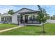 Charming home with a covered front porch, brick walkway, manicured lawn, and fresh white paint at 1050 20 St, Orlando, FL 32805