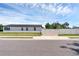 Street view of a modern home, featuring a white fence and manicured lawn at 1050 20 St, Orlando, FL 32805