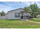 A cozy house with a well-kept lawn, and a charming front porch, complemented by blue skies at 1050 20 St, Orlando, FL 32805