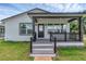 Inviting front porch with dark accents, a brick walkway, and lush green lawn at 1050 20 St, Orlando, FL 32805