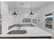 Kitchen island with sink and faucet in a bright open concept house and view to the living room at 1050 20 St, Orlando, FL 32805