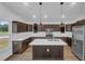 Bright kitchen features dark cabinets, stainless steel appliances, white countertops and island with pendant lights at 1050 20 St, Orlando, FL 32805
