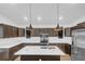 Bright kitchen features dark cabinets, stainless steel appliances, white countertops, and pendant lighting at 1050 20 St, Orlando, FL 32805