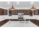Bright kitchen features dark cabinets, stainless steel appliances, white countertops, island with pendant lights at 1050 20 St, Orlando, FL 32805