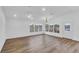 Spacious living room featuring hardwood floors, natural light, and access to the outdoor porch at 1050 20 St, Orlando, FL 32805