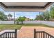 Cozy covered patio offers a view of the fenced yard and surrounding lush greenery at 1050 20 St, Orlando, FL 32805