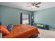 This bedroom offers a cozy retreat with a ceiling fan, window, and comfortable couch at 1064 Universal Rest Pl, Kissimmee, FL 34744
