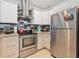 Updated kitchen with stainless steel appliances, stylish backsplash, and modern cabinetry, offering convenience and style at 1064 Universal Rest Pl, Kissimmee, FL 34744