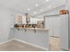 Well-lit kitchen featuring stainless steel appliances, sleek cabinetry, and a breakfast bar, great for casual dining at 1064 Universal Rest Pl, Kissimmee, FL 34744