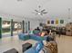 Spacious living room with natural light, ceiling fan, and a comfortable sectional sofa, perfect for relaxation at 1064 Universal Rest Pl, Kissimmee, FL 34744