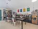 Versatile living and dining area with custom shelving, offering style and functionality for entertaining and storage at 1064 Universal Rest Pl, Kissimmee, FL 34744