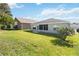 Well-maintained backyard featuring lush green grass and mature landscaping surrounding the property at 1111 High Vista Dr, Davenport, FL 33837