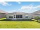 Backyard featuring a well-maintained lawn and the rear exterior of the home at 1111 High Vista Dr, Davenport, FL 33837