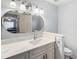 Bathroom features a large vanity, large mirror, updated lighting, and a view into the bedroom at 1111 High Vista Dr, Davenport, FL 33837