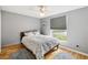 Bedroom has wood floors, a ceiling fan, a large window, and neutral paint at 1111 High Vista Dr, Davenport, FL 33837