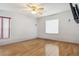 Bedroom has wood floors and an updated ceiling fan and lighting at 1111 High Vista Dr, Davenport, FL 33837