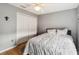 Cozy bedroom featuring a ceiling fan, hardwood floors, and a closet with white bi-fold doors at 1111 High Vista Dr, Davenport, FL 33837