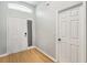 Bright entryway featuring a wood floor, entry door, and a coat closet at 1111 High Vista Dr, Davenport, FL 33837