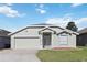 Lovely one-story home featuring a well-kept lawn and a convenient two-car garage at 1111 High Vista Dr, Davenport, FL 33837