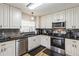 Bright kitchen features stainless steel appliances, modern cabinets, and sleek black countertops at 1111 High Vista Dr, Davenport, FL 33837