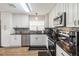 Bright kitchen features stainless steel appliances, modern cabinets, and sleek black countertops at 1111 High Vista Dr, Davenport, FL 33837