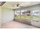Enclosed lanai showcasing outdoor views from large windows and a ceiling fan at 1111 High Vista Dr, Davenport, FL 33837