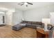 Spacious living room with wood flooring, a ceiling fan, and a cozy sectional sofa at 1111 High Vista Dr, Davenport, FL 33837
