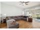 Bright living area features wood floors, a large sectional, and sliding glass doors at 1111 High Vista Dr, Davenport, FL 33837