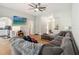 Inviting living room features wood flooring, a ceiling fan, and a spacious sectional sofa at 1111 High Vista Dr, Davenport, FL 33837