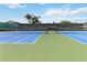 Bright blue and green tennis courts with well-maintained nets and fencing for recreational enjoyment at 1111 High Vista Dr, Davenport, FL 33837