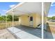 Exterior backyard features covered porch, and white door with light at 1125 Emerald Dr, Mount Dora, FL 32757