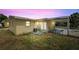 Backyard features a patio, grass and yellow exterior paint at 1125 Emerald Dr, Mount Dora, FL 32757