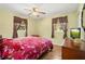 Bedroom with hardwood floors, ceiling fan, and matching wood dresser at 1125 Emerald Dr, Mount Dora, FL 32757