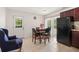 Bright dining area with tile floors, a round table and chairs, and an outdoor access door at 1125 Emerald Dr, Mount Dora, FL 32757