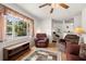 Hardwood floored living room featuring a large window for natural light and a comfortable seating area at 1125 Emerald Dr, Mount Dora, FL 32757