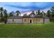 Beautiful single-story home featuring a modern farmhouse design and inviting front porch with wood columns at 12193 Sw 69 Pl, Ocala, FL 34481
