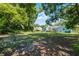 View of the expansive, tree-lined backyard with plenty of space for recreation at 1225 W Smith St, Orlando, FL 32804