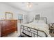 Comfortable bedroom with wood dresser, metal frame bed, and bright windows at 1225 W Smith St, Orlando, FL 32804