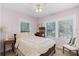 Charming bedroom with a floral quilt, three windows, and light pink walls at 1225 W Smith St, Orlando, FL 32804