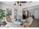 Well-lit dining room with a glass table, wicker chairs, and open access to other living spaces at 1225 W Smith St, Orlando, FL 32804
